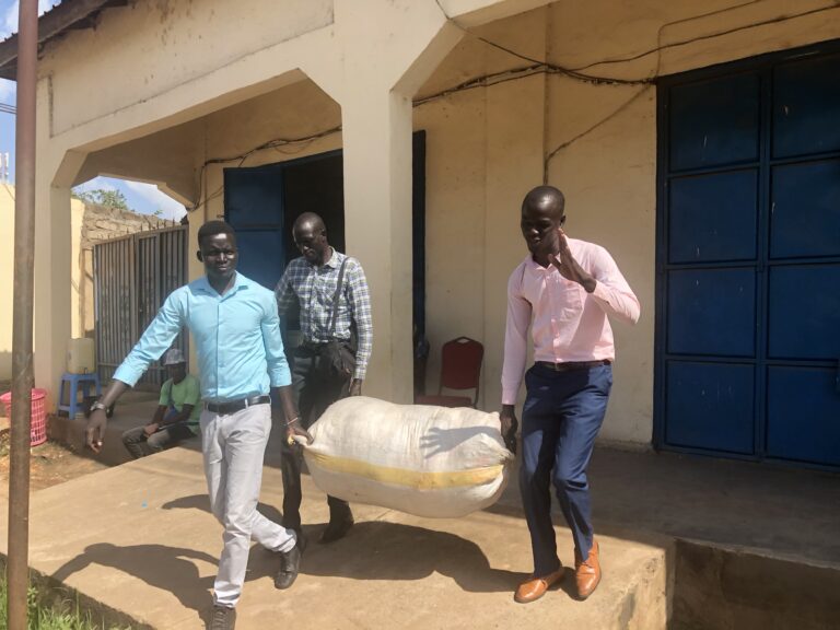 ujoss and number one citizen staff carrying their donation